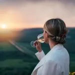 Side view of woman tasting white wine